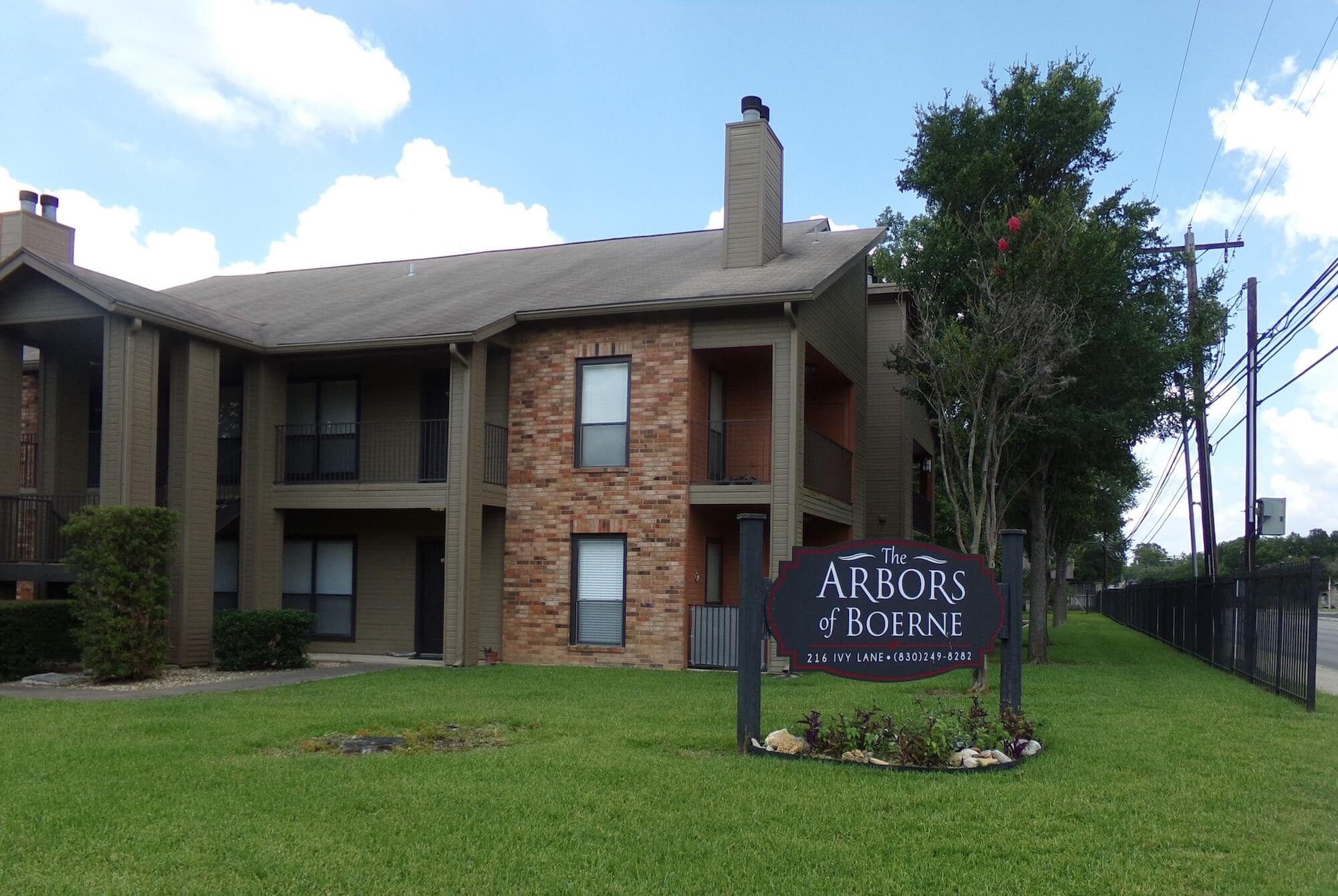 Arbors of Boerne Apartments sign and front of community.