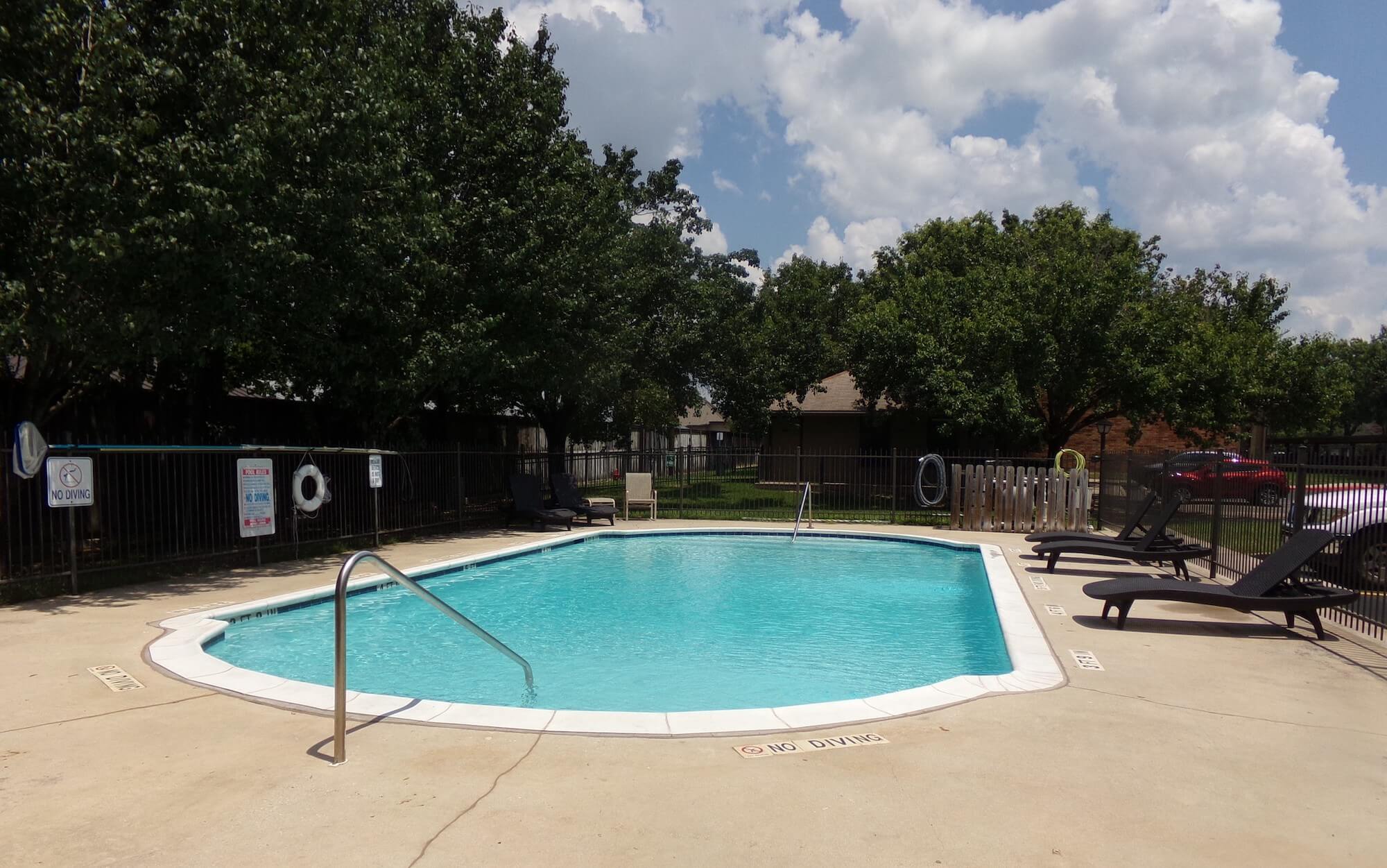 Arbors of Boerne Apartments bright blue pool area.