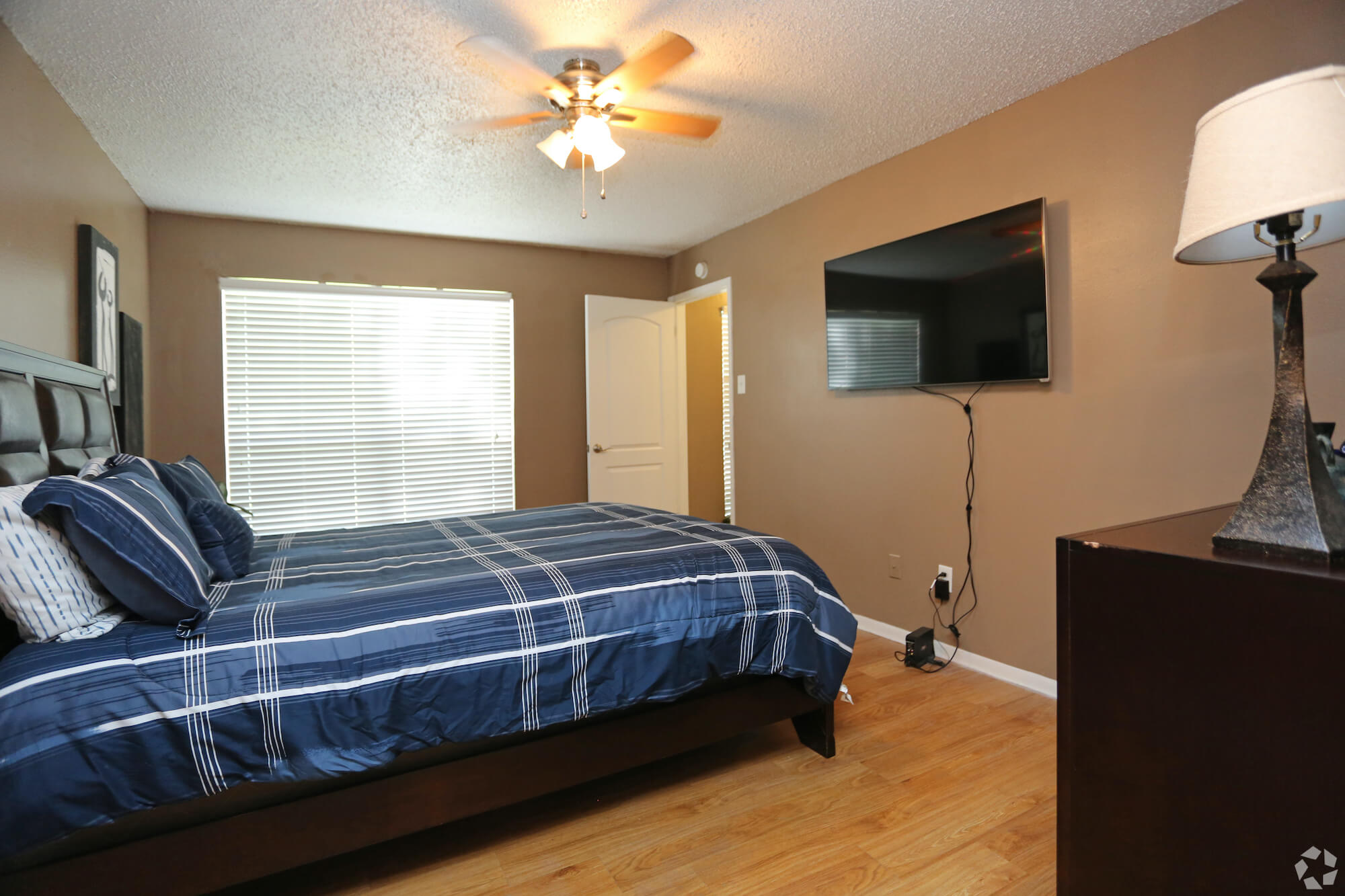 Arbors of Boerne Apartments bedroom with ceiling fan.