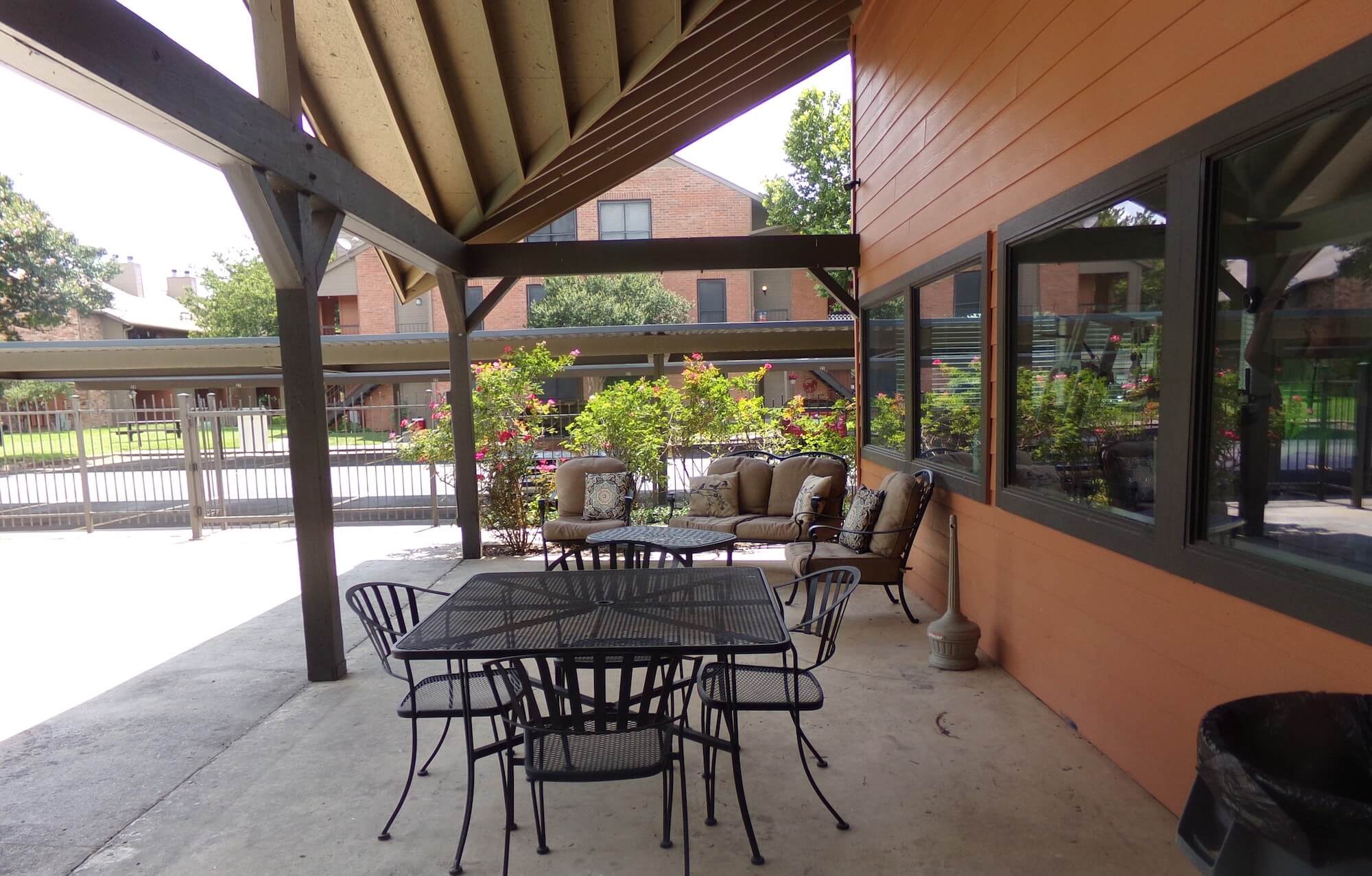 Arbors of Boerne Apartments patio and seating area beside pool.